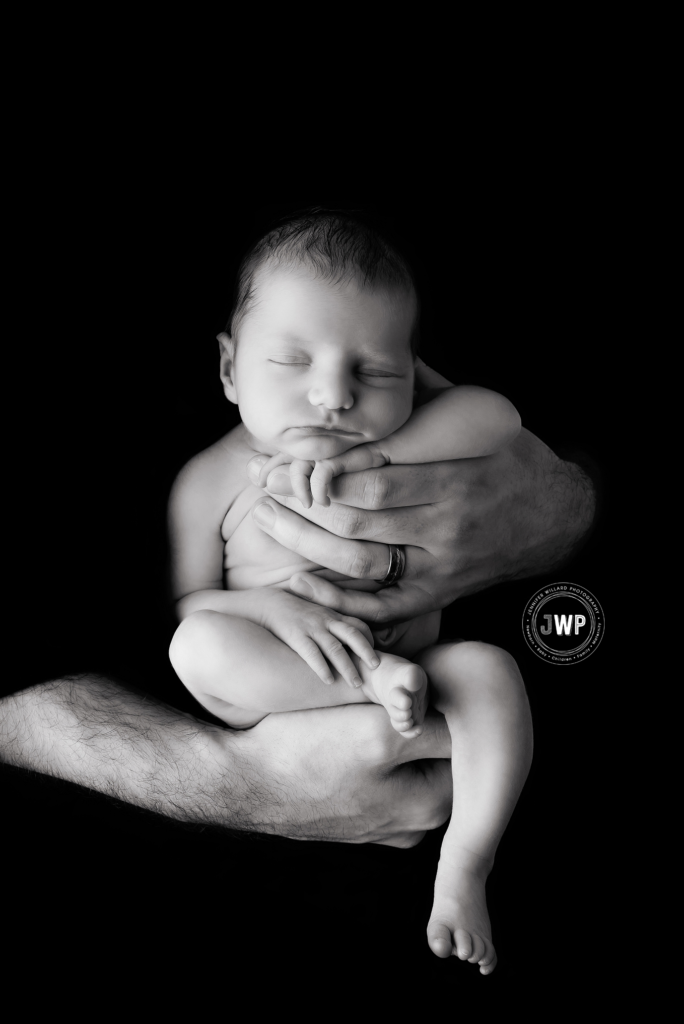 baby girl fathers arms black and white