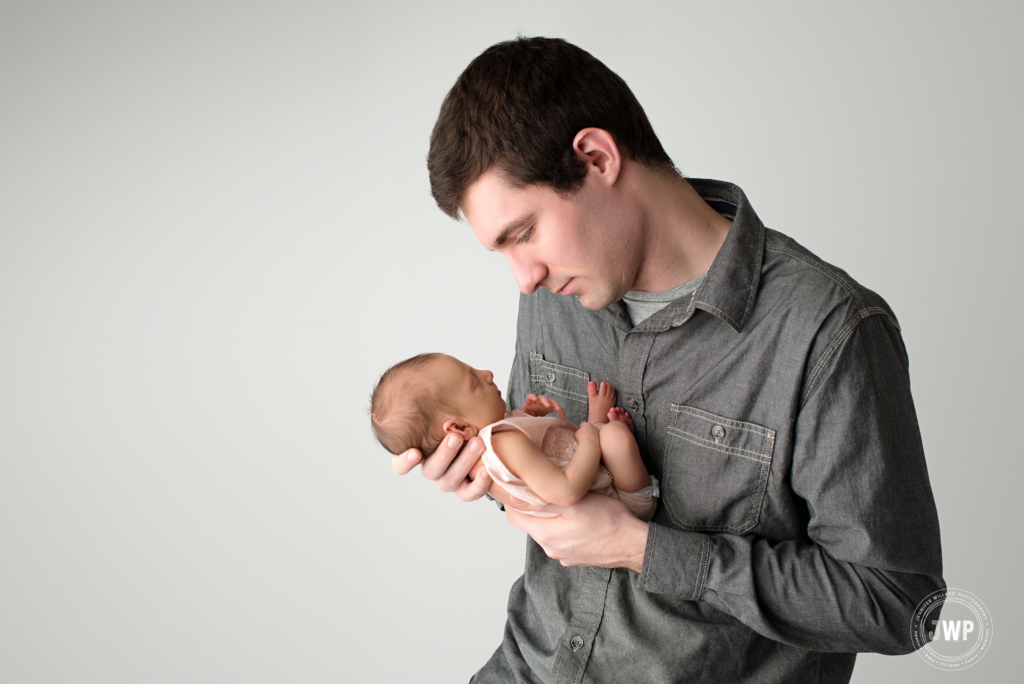 father looking down newborn baby girl Kingston Photographer