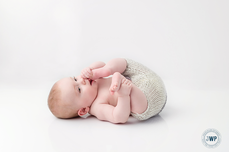 newborn-baby-boy-knit-pants-white-backdrop-Kingston-Baby-Photographer