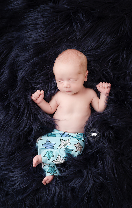 newborn-baby-boy-star-pants-blue-flokati-rug-Kingston-Newborn-Photographer