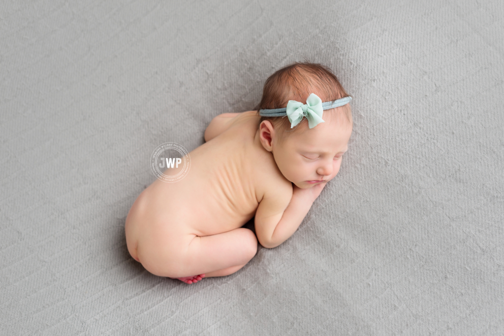 newborn baby girl picture from above with mint bow Kingston Newborn Photographer