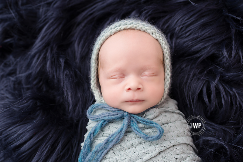 newborn-boy-in-sage-wrap-with-bonnet-by-Kingston-Baby-Photographer