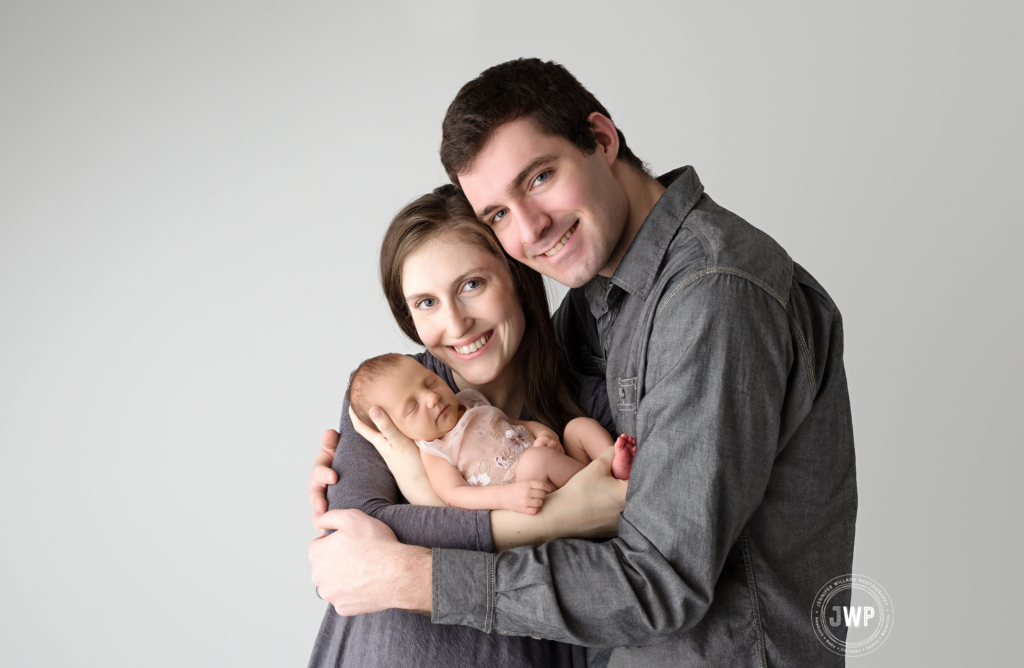 newborn girl with parents smiling with Kingston Newborn Photographer