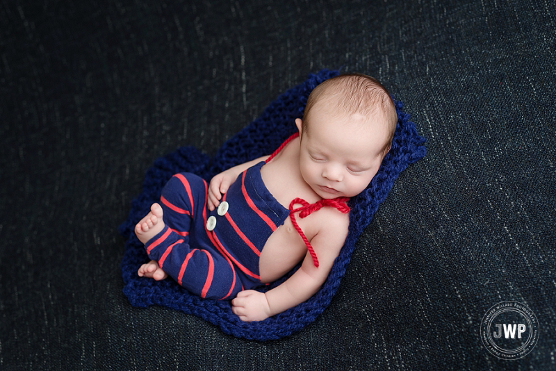 newborn posed portrait blue red romper blue blanket Kingston Newborn Photographer