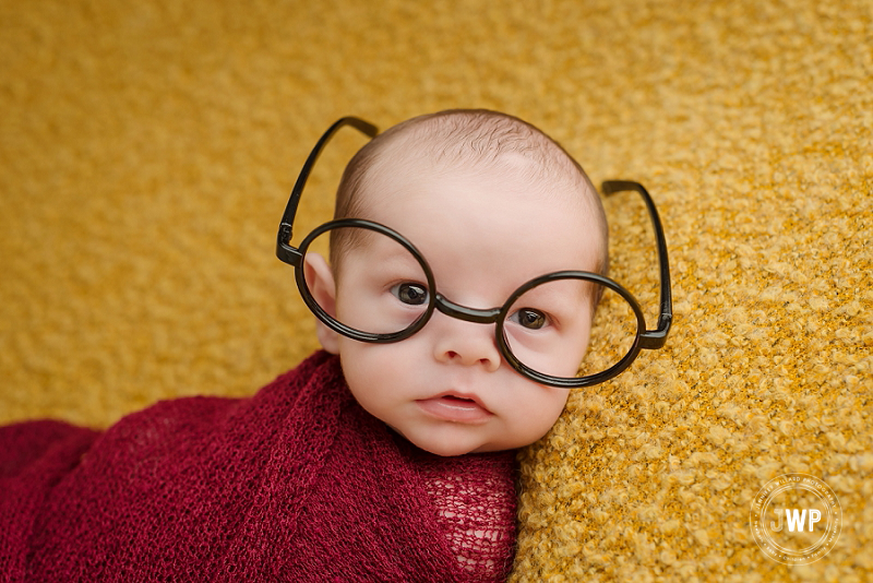 newborn posed portrait yellow blanket burgundy wrap Harry Potter glasses Kingston Newborn Photographer