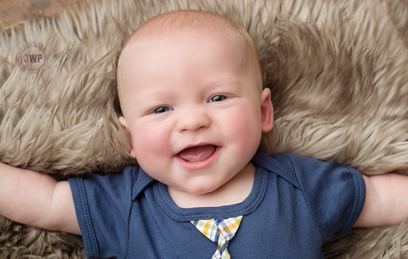 posed baby portrait 6 months old wood backdrop fur Kingston Children Photographer