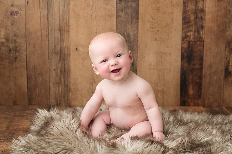 posed baby portrait 6 months old wood backdrop fur Kingston Children Photographer