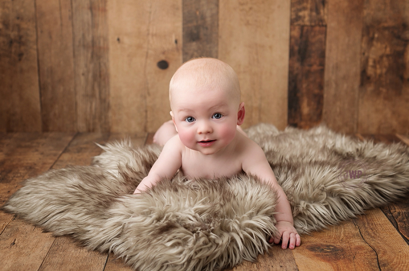 posed baby portrait 6 months old wood backdrop fur Kingston Children Photographer