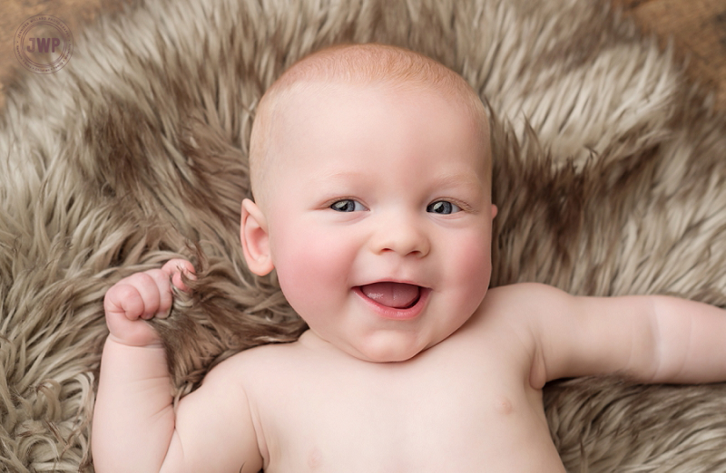 posed baby portrait 6 months old wood backdrop fur Kingston Children Photographer