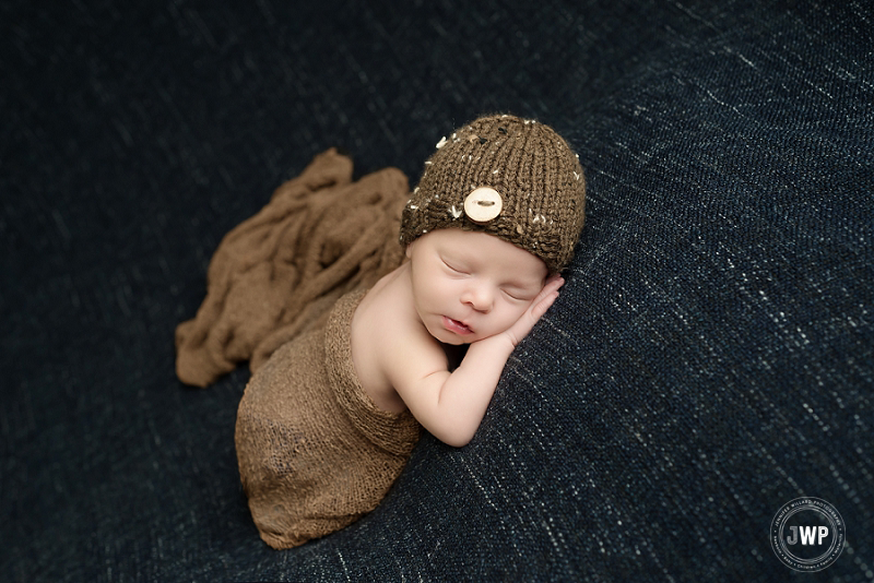 posed newborn picture blue blanket brown hat wrap Kingston Newborn Photographer