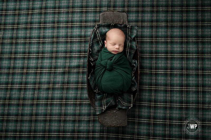 posed newborn picture green knot wrap plaid trench bowl Kingston Newborn Photographer