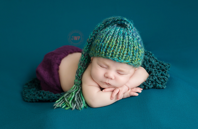 posed newborn picture teal blanket teal hat Kingston Newborn Photographer