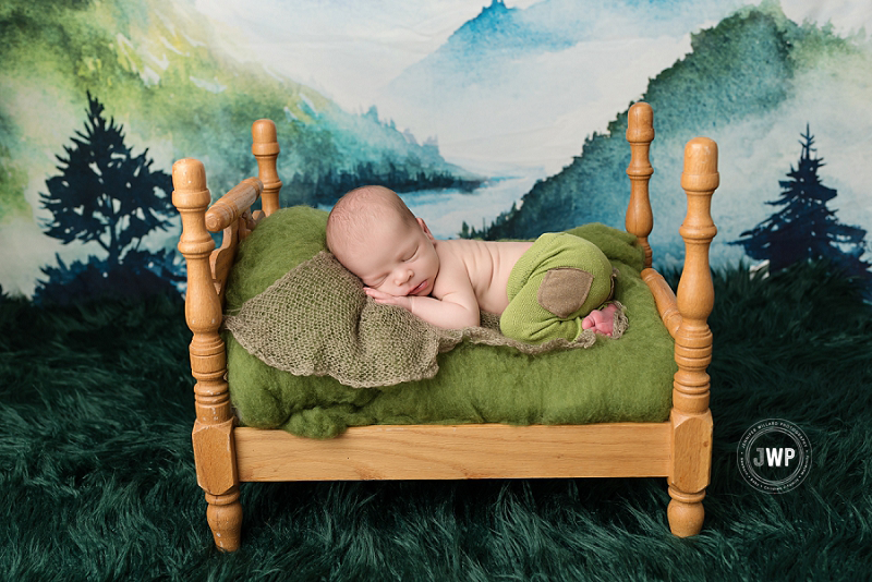 posed newborn portrait boy green pants brown bed trees Kingston Newborn Photographer