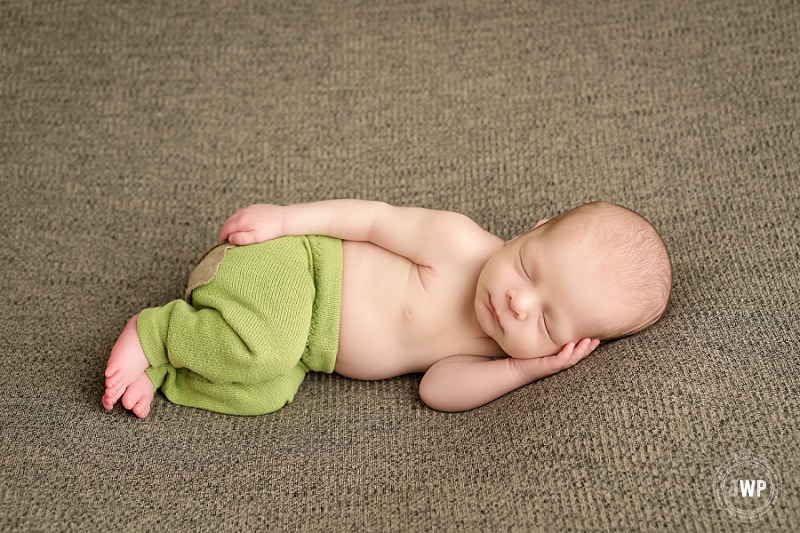 posed newborn portrait boy green pants brown blanket Kingston Newborn Photographer