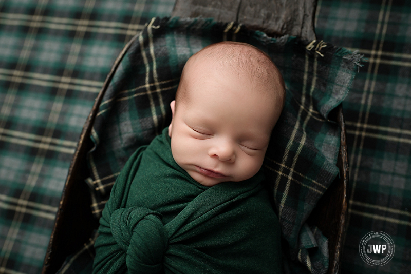 posed newborn portrait boy green plaid wrap Kingston Newborn Photographer