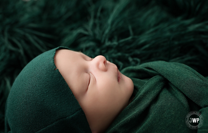 posed newborn portrait boy green wrap hat fur Kingston Newborn Photographer