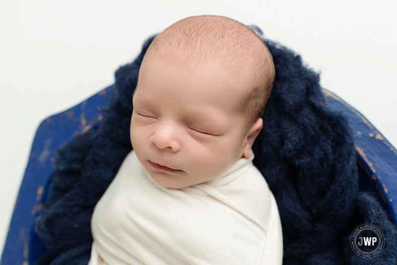 posed newborn portrait boy white wrap blue felt wood bowl Kingston Newborn Photographer