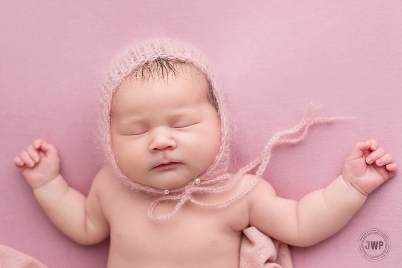 posed newborn portrait pink blanket pink hat Kingston Newborn Photographer