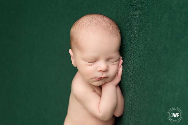 side lying posed newborn picture green blanket close up Kingston Newborn Photographer