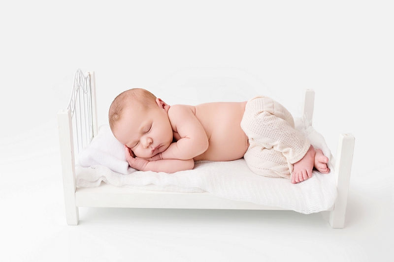 Posed Newborn Portrait baby boy on bed Kingston Baby Photographer