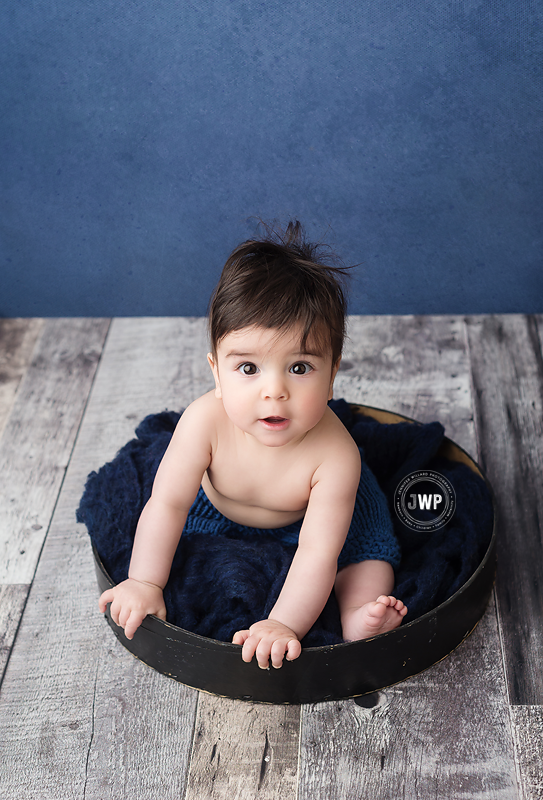 posed baby portrait bucket blue backdrop Kingston Portrait Studio