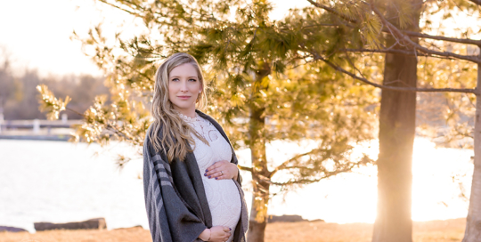 posed maternity picture sunset lakeside pine trees Kingston Maternity Photographer