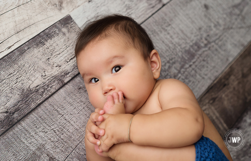 baby boy 7 months old grey floor eating toes Kingston photographer