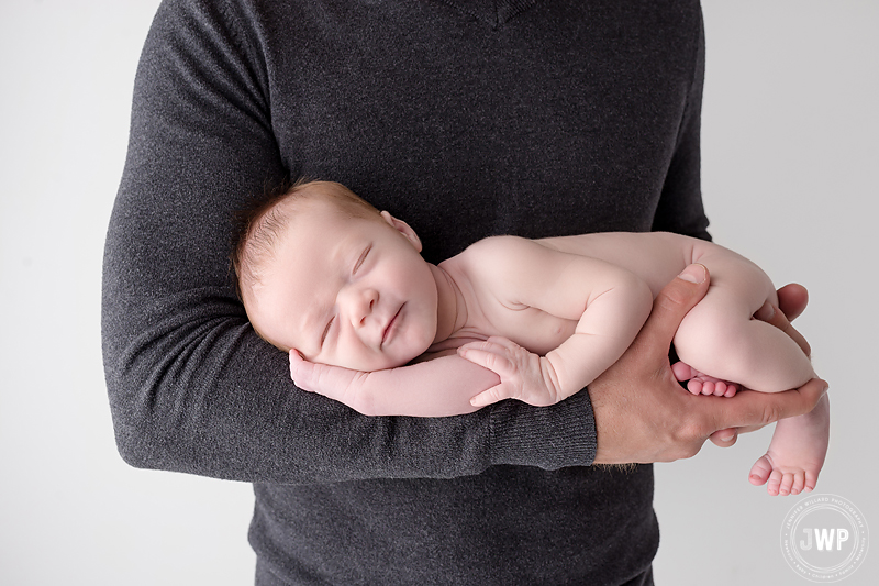 baby boy in fathers arms Kingston newborn photographer