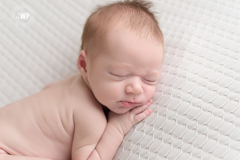 baby boy white blanket lying on tummy Kingston newborn photographer