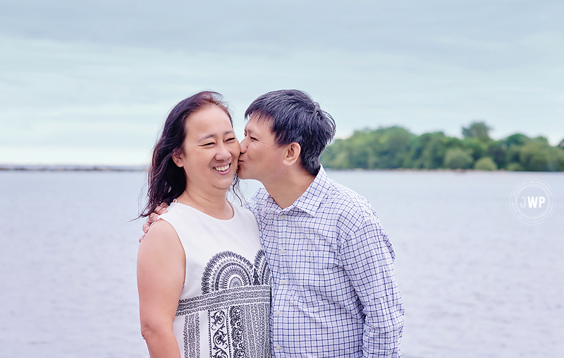 husband wife kissing lakefront Kingston Ontario Photographer