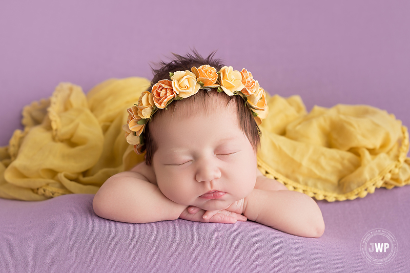 newborn girl head on hand yellow wrap flower headband purple Kingston Photographer