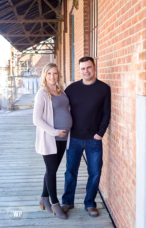 pregnant mother father leaning on brick wall Gananoque maternity photographer