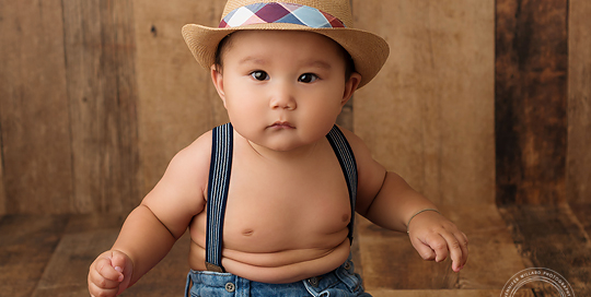 red scarf fedora hat suspenders wood backdrop Kingston baby photographer