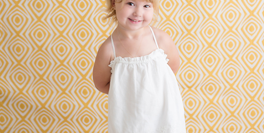 toddler girl yellow backdrop white dress flower crown Kingston children photographer