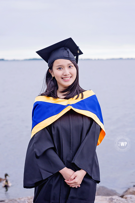 woman graduating university Queens lakefront graduation photographer kingston ontario