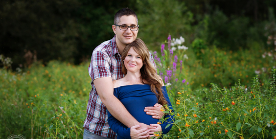 couple pregnant mother flower field blue dress Kingston maternity photographer