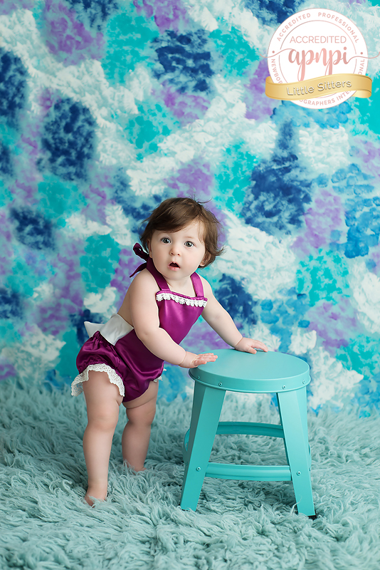 6 month baby girl purple romper blue stool APNPI Accredited Baby Photographer Kingston Photographer