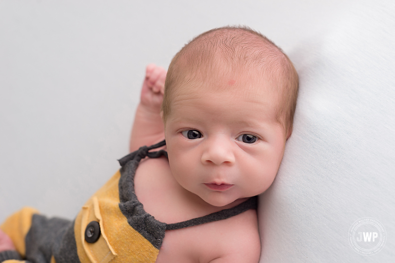 baby boy wide eyed striped romper white blanket Kingston children photographer