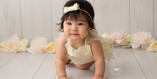 baby girl in cream romper with cream and ivory flowers Kingston photographer