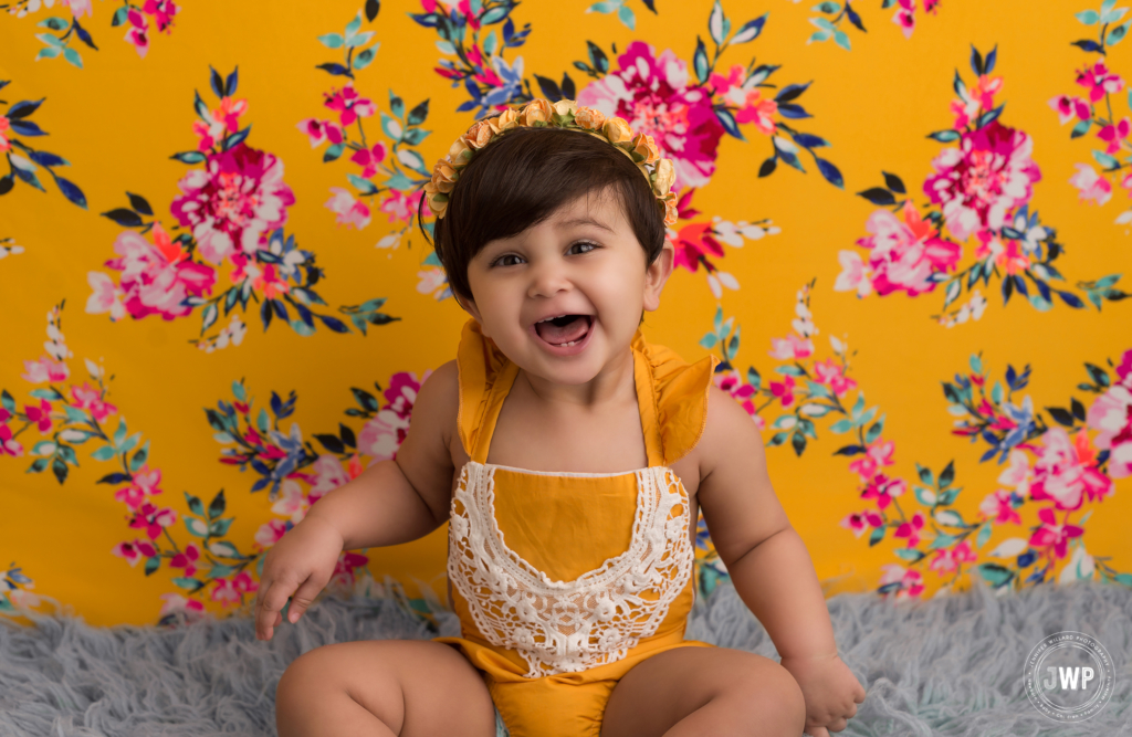 baby romper yellow pink backdrop first birthday portraits Kingston photographer