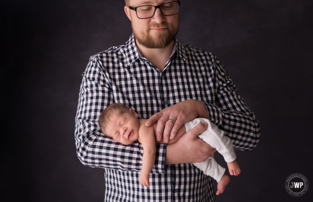 father baby sleeping on arms Kingston newborn photographer