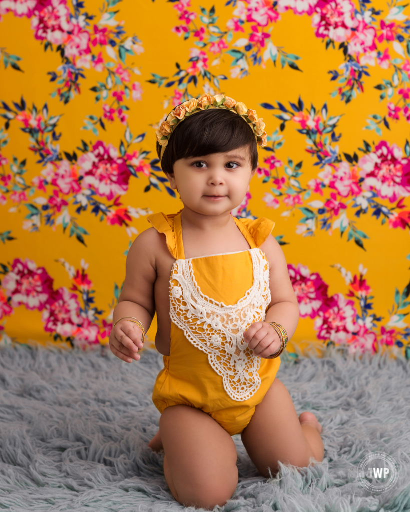 first birthday milestone yellow romper floral crown Kingston baby photographer