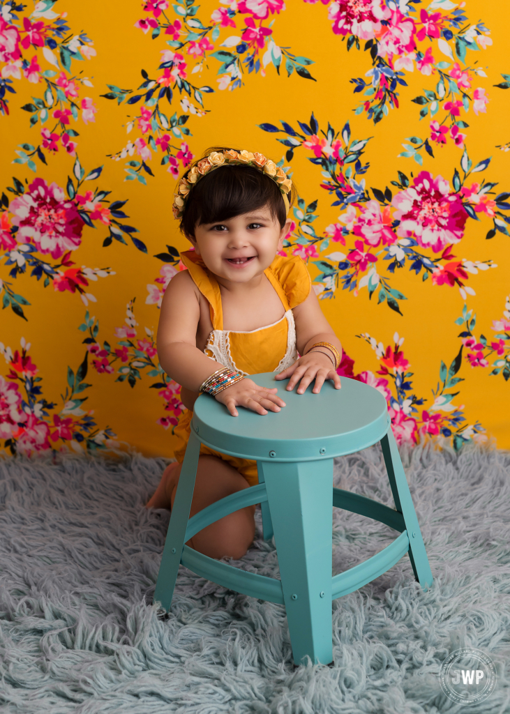 first birthday yellow romper floral crown blue stool Kingston baby photographer