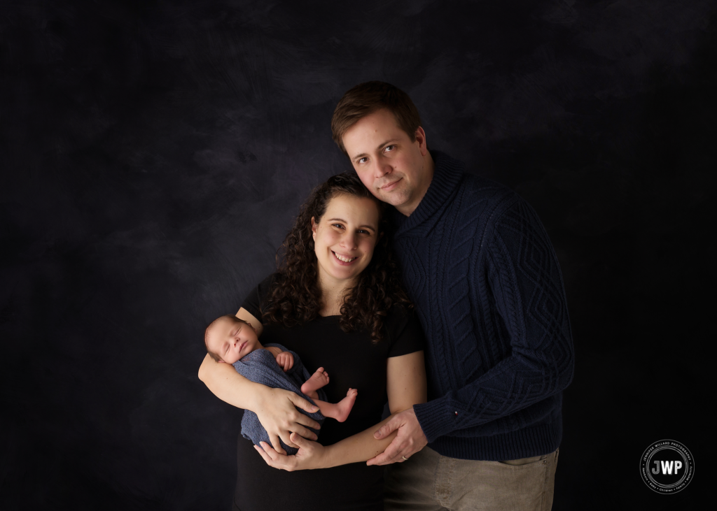 newborn boy mother father black backdrop Kingston ontario family photographer