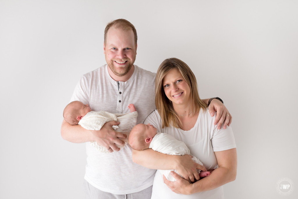 twins wrapped parent pose Kingston newborn photographer APNPI