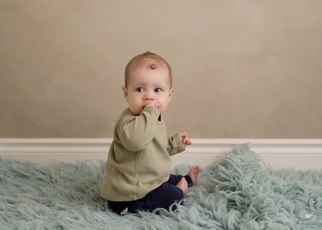 6 month old baby milestone blue flokati beige backdrop Brockville portrait photographer