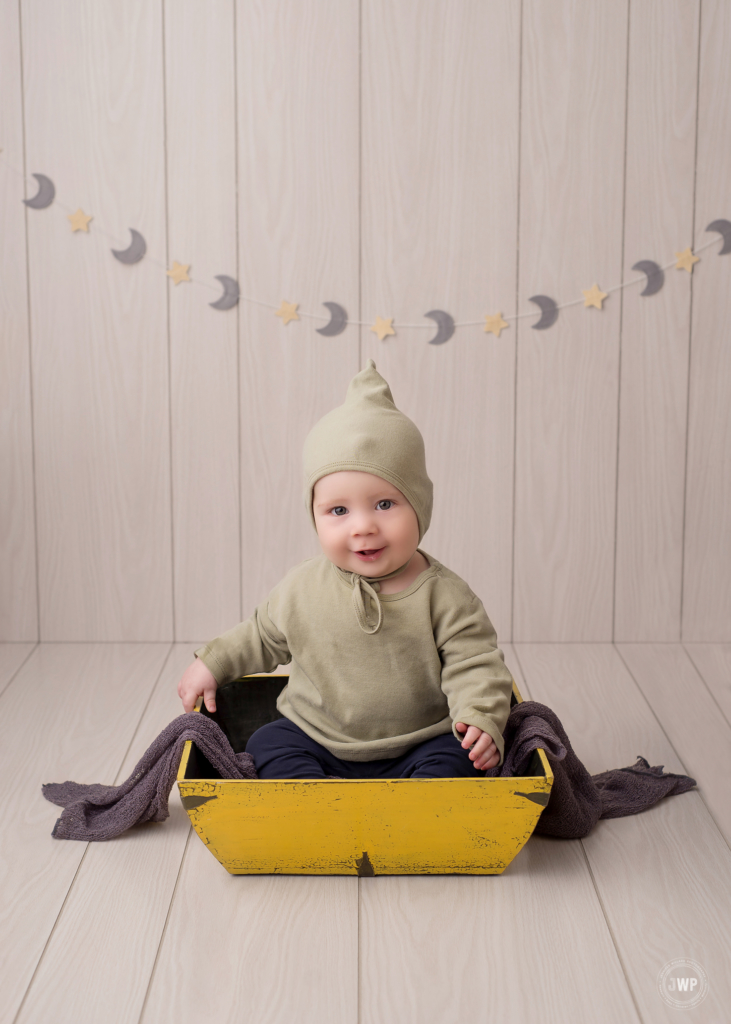 6 month old sitter milestone white wood backdrop yellow crate Kingston baby photographer