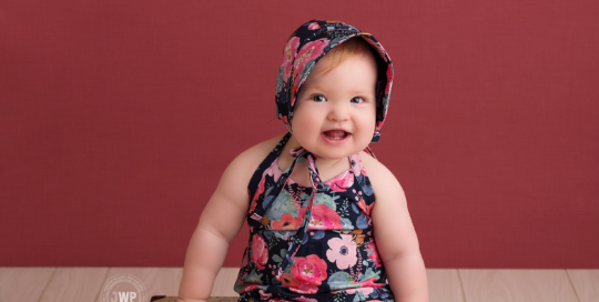 baby girl flower romper bonnet pink backdrop blue suitcase kingston first birthday photographer