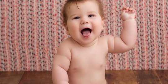 6 month old baby boy blue and orange backdrop wood floor kingston baby photographer