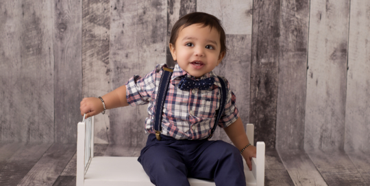 baby boy 1st birthday bowtie suspenders grey wood backdrop Kingston photographer